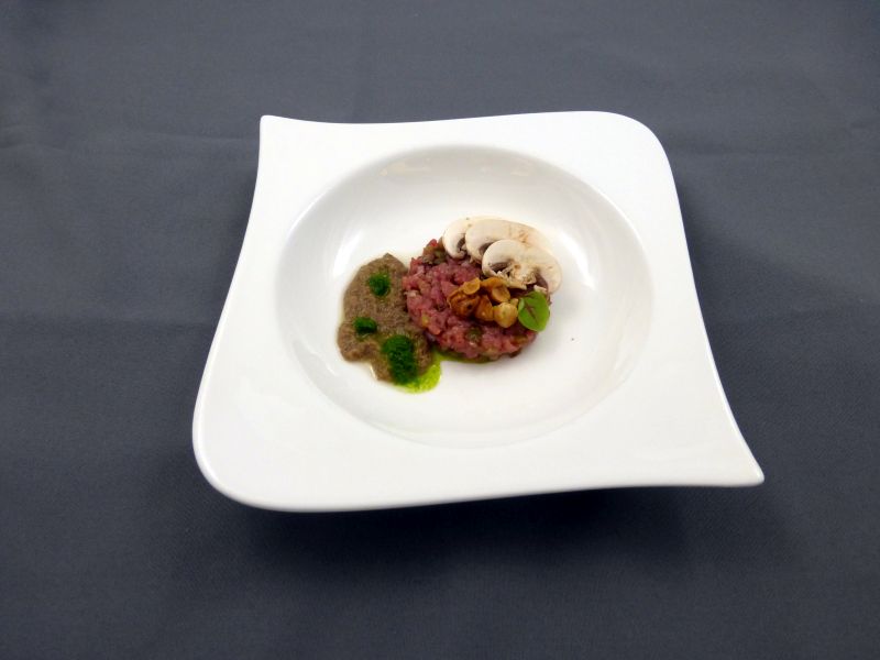 Tartaar van kalfsoester afgewerkt met champignon hazelnoot en bieslook